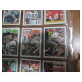 Double sided page of sports cards including Cal Ripken, Wade Boggs, Mark McGuire, Darryl Strawberry, Jose Canseco and others