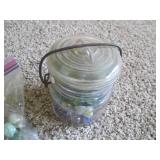 Lidded jar and bag of vintage marbl...