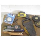 Variety of tape measures, levels, c...
