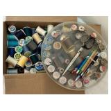 Various spools of thread, misc sewing notions