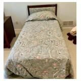 Vintage French Provincial style twin bed, dark wood frame with a cushioned, light green floral upholstered headboard