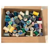 Various spools of thread, misc sewing notions