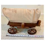 Vintage miniature wooden covered wagon with celluloid people toy display