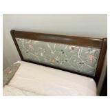 Vintage French Provincial style twin bed, dark wood frame with a cushioned, light green floral upholstered headboard