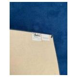 Blue area rug with distinctive cream-colored floral border pattern