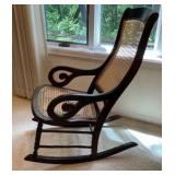 Vintage rocking chair cherry wood framed, light colored woven cane back and seat
