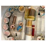Various spools of thread, misc sewing notions