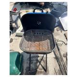 Portable charcoal grills, one green and one blue
