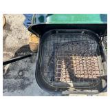Portable charcoal grills, one green and one blue