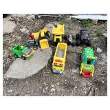 Toy vehicles including trucks, school bus, and toy dump trucks