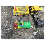 Toy vehicles including trucks, school bus, and toy dump trucks