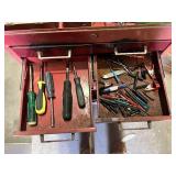 Metal Tool Chest with Tools including screwdrivers, hammers, saws, measuring tapes, and brushes