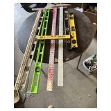 Assorted Levels and Measuring Tools including Laser Level, Stanley Level, Metal T-Square, and Carpenter Levels
