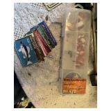 Maps, fishing guides, and fishing gear with binoculars and telescopes.