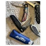 Knife collection including Gerber and Winchester knives, and a Sunnen honing stone