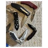 Knife collection including Gerber and Winchester knives, and a Sunnen honing stone
