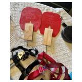 Various pet accessories including leashes, harnesses, and training tools, with dog-related supplies such as pee pads