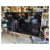 TCL Flat Screen TV with HDMI and AV Inputs 56 1/2" Wide - Lights Up in Back, Needs Remote
