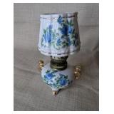 Vintage Royal Crown miniature oil lamp featuring hand-painted blue floral motifs and gold trim