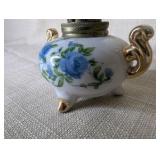 Vintage Royal Crown miniature oil lamp featuring hand-painted blue floral motifs and gold trim