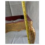 Italian Florentine side table from the 1950s,distinctive weathered gold gilt finish over a red base