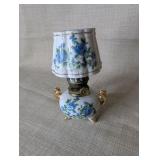Vintage Royal Crown miniature oil lamp featuring hand-painted blue floral motifs and gold trim