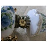 Vintage Royal Crown miniature oil lamp featuring hand-painted blue floral motifs and gold trim