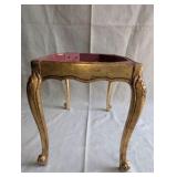 Italian Florentine side table from the 1950s,distinctive weathered gold gilt finish over a red base