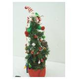 festive Christmas tree with flashing lights and Santa on top