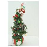 festive Christmas tree with flashing lights and Santa on top