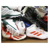 Assorted pairs of new football clea...