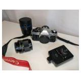 Vintage Canon AE-1 Program 35mm film SLR camera, Canon FD 100mm f/2.8 telephoto lens, Canon Speedlite 188A electronic flash unit