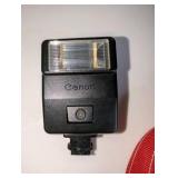 Vintage Canon AE-1 Program 35mm film SLR camera, Canon FD 100mm f/2.8 telephoto lens, Canon Speedlite 188A electronic flash unit