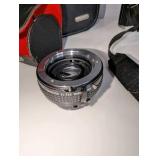 Minolta XG-7 35mm SLR film camera includes black carrying case, 2x auto tele converter