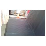 Black vinyl-covered gymnasium safety wall padding with foam core.