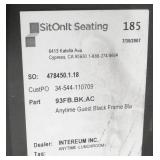 Four black plastic stacking chairs