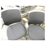 4 chairs - 2 are white and grey vinyl and 2 are grey fabric