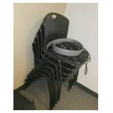 FIVE black stacking chairs
