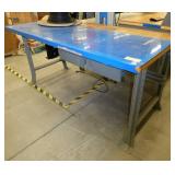 72x36 Workbench with wood top and steel legs, and a couple of drawers, top is covered with a plastic