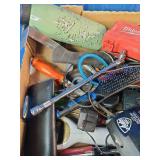This box contains a mix of miscellaneous garage items, hand tools, small electronics, and personal care products.