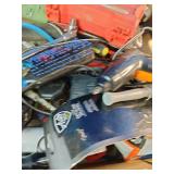 This box contains a mix of miscellaneous garage items, hand tools, small electronics, and personal care products.