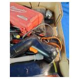 This box contains a mix of miscellaneous garage items, hand tools, small electronics, and personal care products.