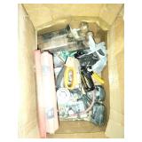 This box contains a variety of mixed garage and shop tools, including a red plastic case and a staple gun.