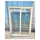 Vinyl sliding window features a desert sand color