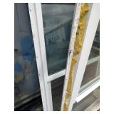 (2)  Vector brand white vinyl single-hung window featuring a prominent blue logo sticker on the glass.