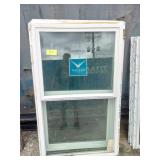 (2)  Vector brand white vinyl single-hung window featuring a prominent blue logo sticker on the glass.