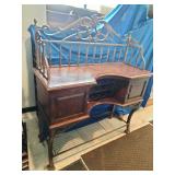 This French country-style bar console features a rich wood top and a decorative wrought iron frame