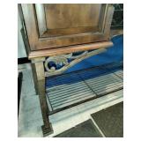 This French country-style bar console features a rich wood top and a decorative wrought iron frame