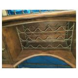 This French country-style bar console features a rich wood top and a decorative wrought iron frame