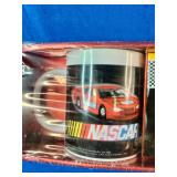 2005 NASCAR "Flat-Out" Mug Set featuring colorful stock car graphics and includes two coffee mugs.